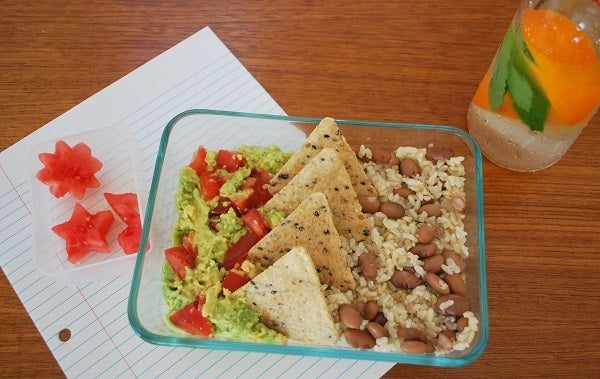 Mexican-themed lunch with guacamole, brown rice, beans, watermelon, and flavored water