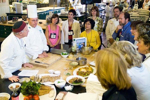 Group of people learning about cooking at Healthy Kitchens Healthy Lives Conference
