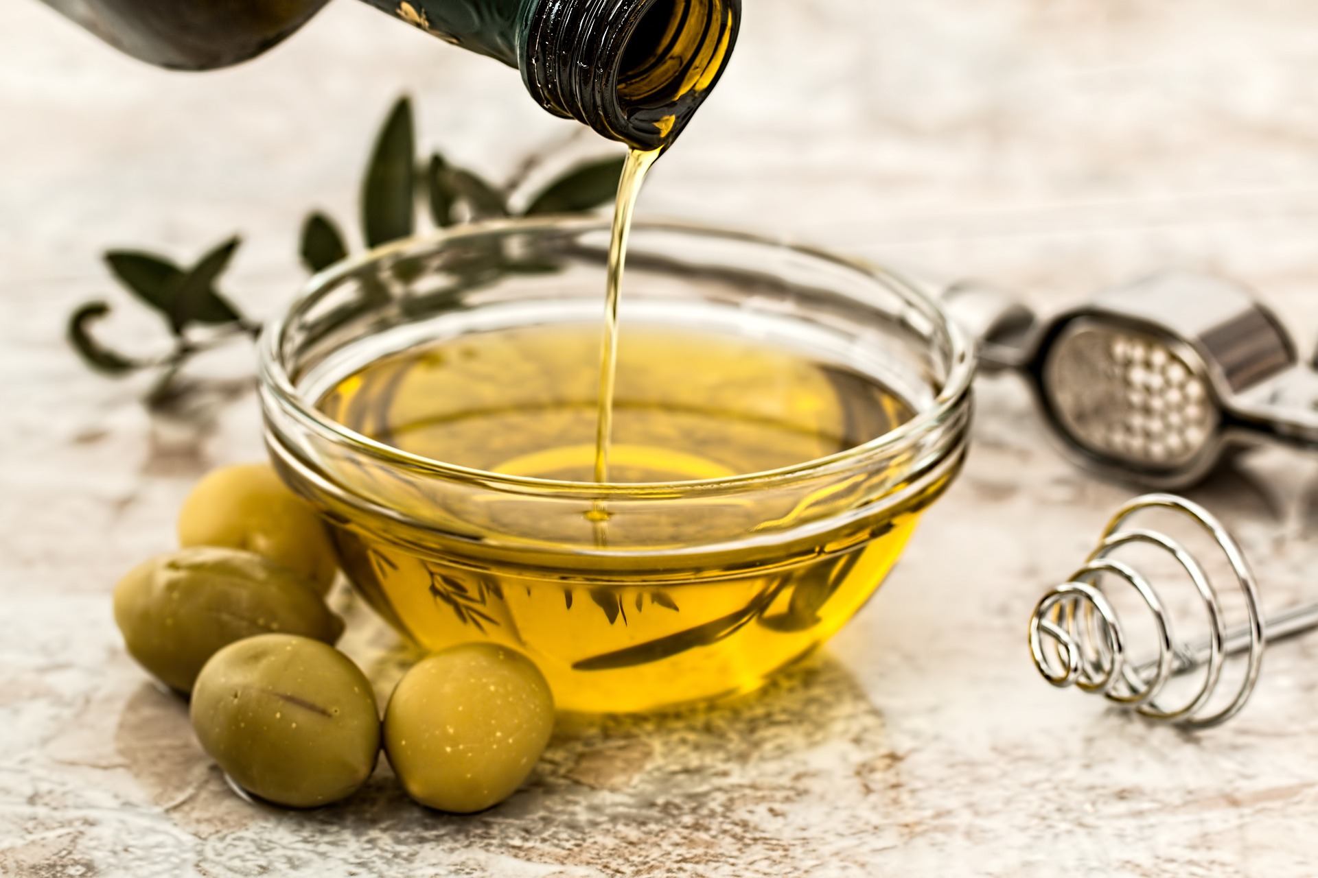 a bowl of olive oil an olives