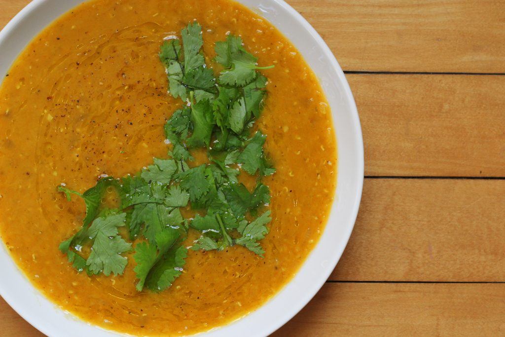 red lentil soup flavored with indian spices and topped with chopped cilantro