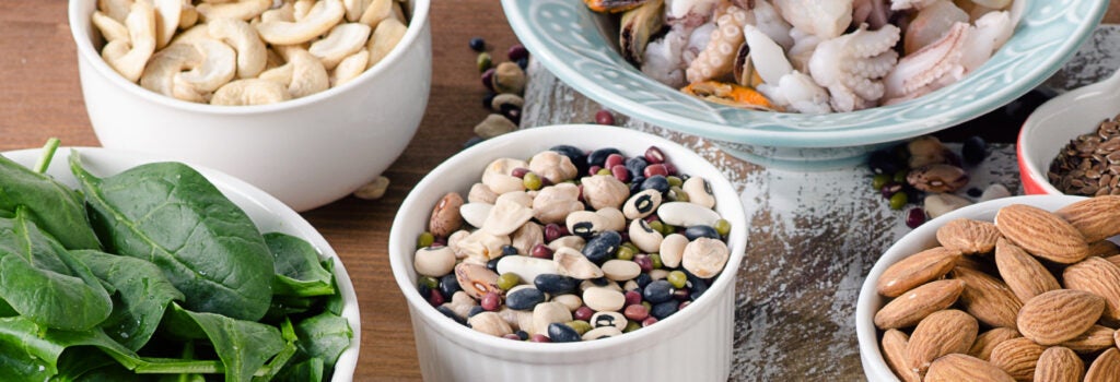 Foods high in manganese including spinach, legumes, nuts, shellfish