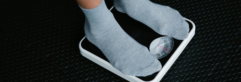 Legs in Socks Standing on Scale