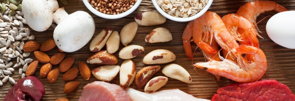 top view of foods High in Selenium such as brasil nuts, tuna, shrimps, beef, liver, mushrooms, pumpkin seeds, sunflower seeds, buckwheat, oatmeal, almonds and eggs