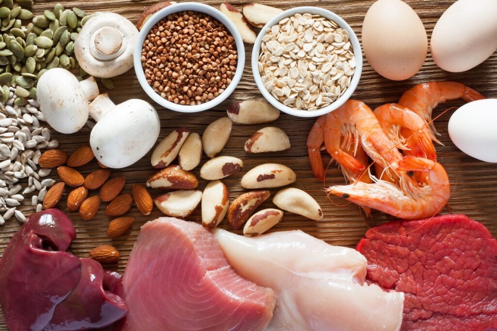 top view of foods High in Selenium such as brasil nuts, tuna, shrimps, beef, liver, mushrooms, pumpkin seeds, sunflower seeds, buckwheat, oatmeal, almonds and eggs