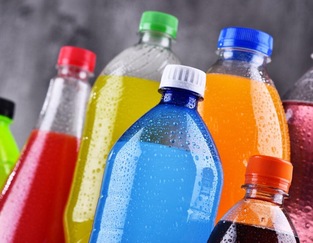 Plastic bottles of assorted carbonated soft drinks in variety of colors