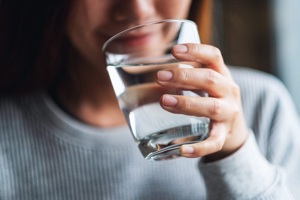 Close up of woman drinking a glass of water