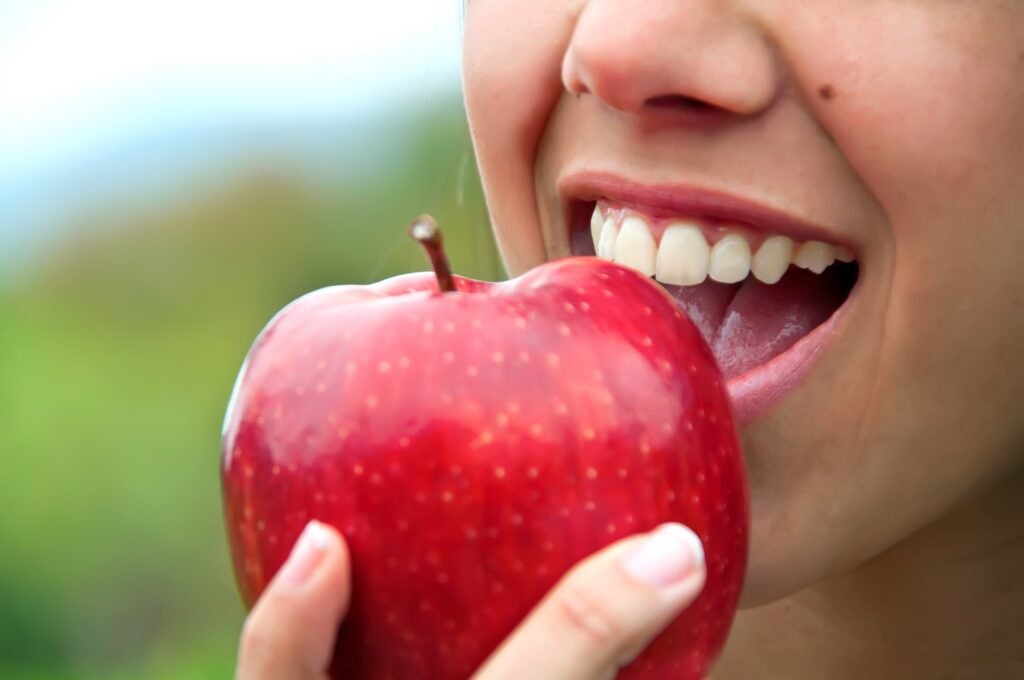 woman biting an apple