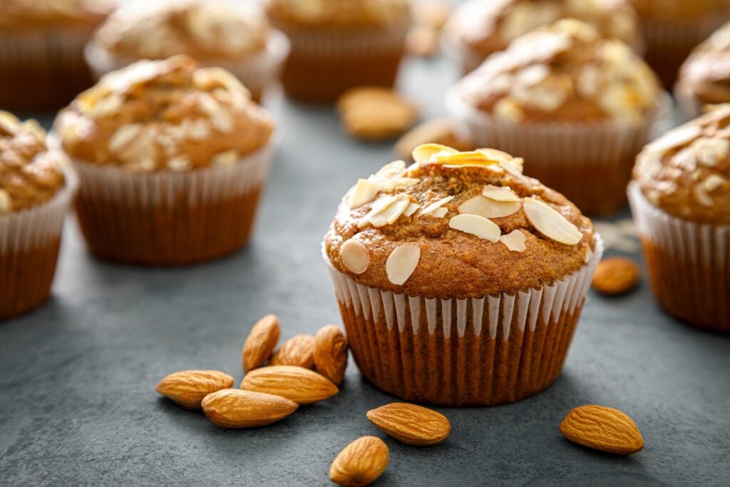 muffins with cliced almonds on top and whole almonds around it