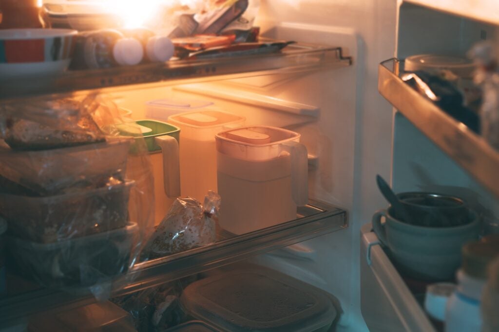 Open fridge with various food and beverage containers