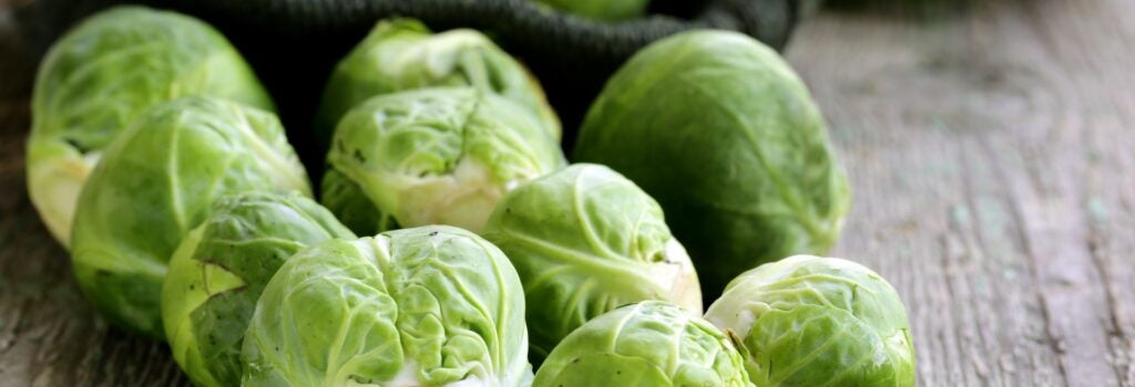 raw brussels sprouts on wood table