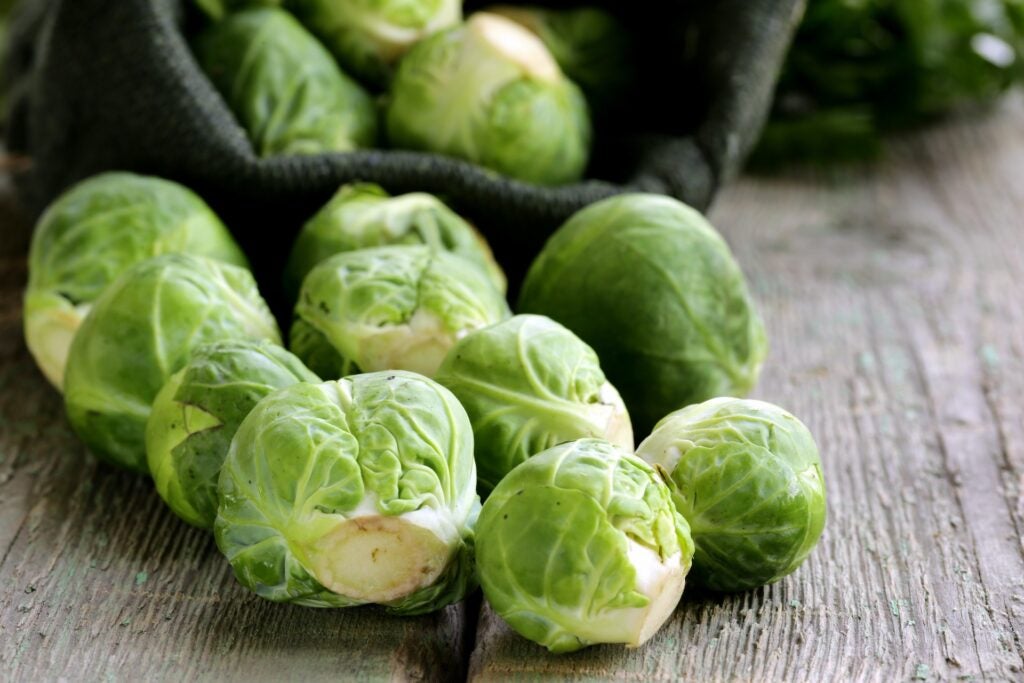 raw brussels sprouts on wood table