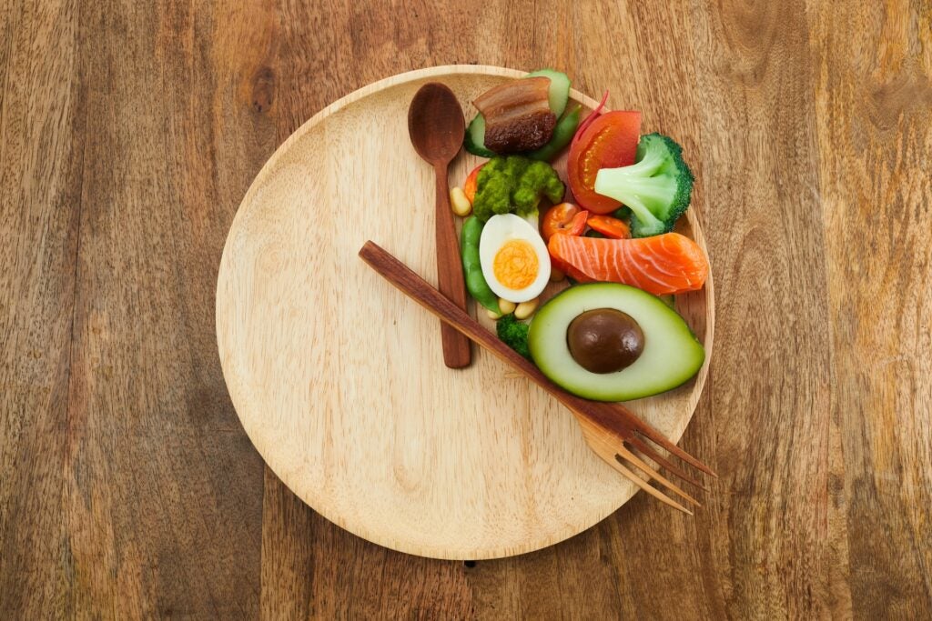 plate and utensils set up to look like a clock with food in the 12-4 area