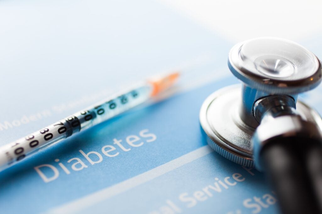 Stethoscope and a syringe on a diabetes test