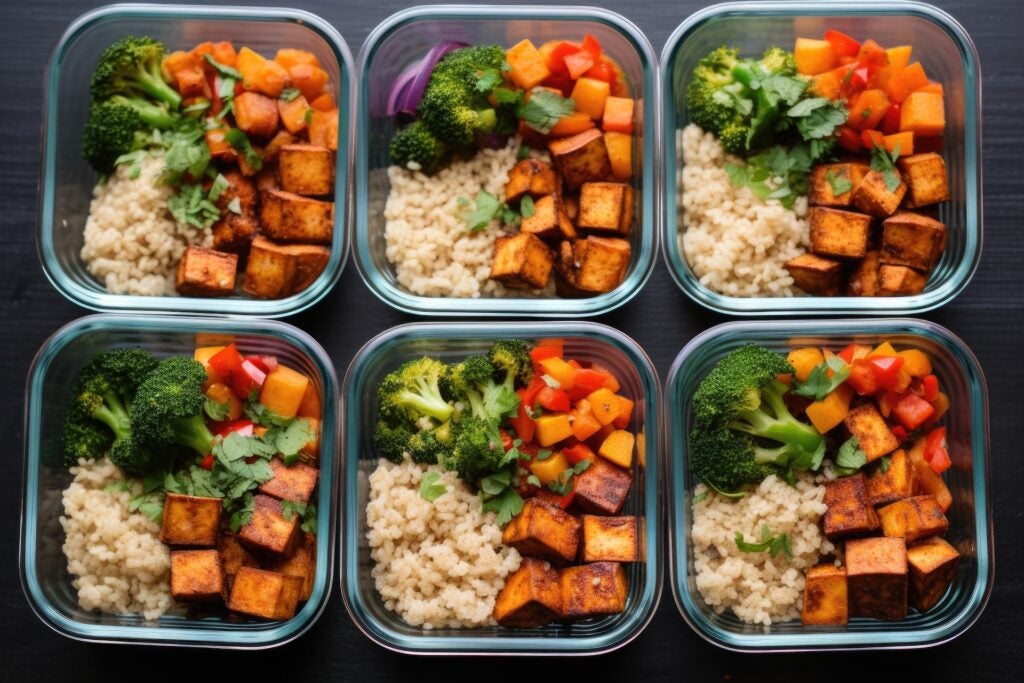 six meal prep containers with tofu and veggies