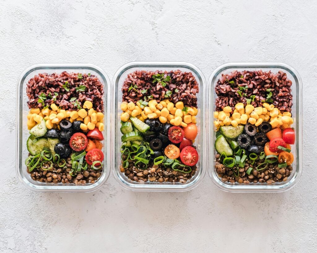 top view of 3 glass containers with meal prep ingredients